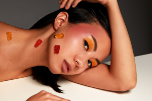 Beauty portrait of a girl with marmalade, Asian woman with a beautiful face and healthy skin, with marmalade, beauty concept